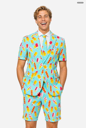 A man modeling a light blue three-piece suit with a colorful ice cream cone pattern, featuring a short-sleeve blazer, matching trousers, and a matching tie, set against a plain light gray background.