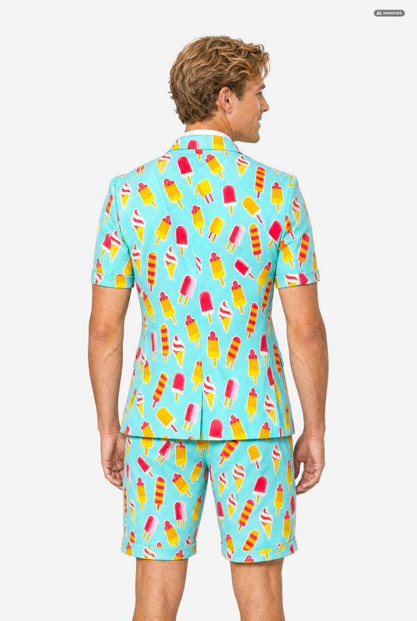 A man modeling a light blue three-piece suit with a colorful ice cream cone pattern, featuring a short-sleeve blazer, matching trousers, and a matching tie, set against a plain light gray background. Viwe from the back.