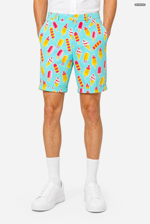 A man modeling a light blue three-piece suit with a colorful ice cream cone pattern, featuring a short-sleeve blazer, matching trousers, and a matching tie, set against a plain light gray background. Shorts close up.