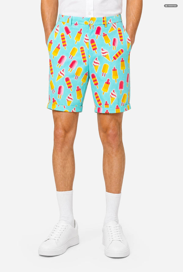 A man modeling a light blue three-piece suit with a colorful ice cream cone pattern, featuring a short-sleeve blazer, matching trousers, and a matching tie, set against a plain light gray background. Shorts close up.