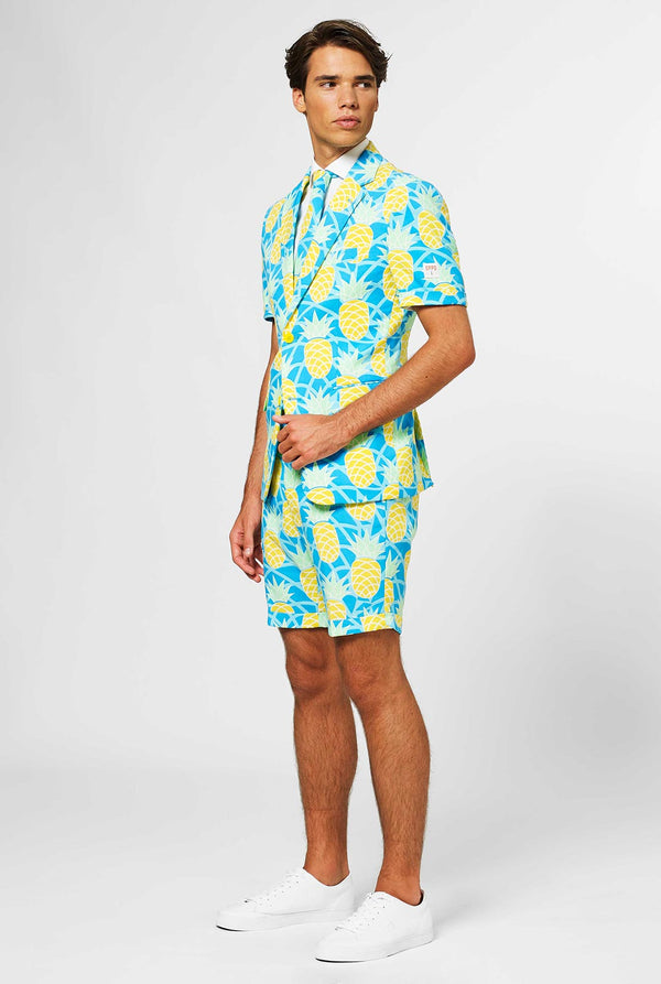 Man wearing blue summer suit with pineapple print. Full body.