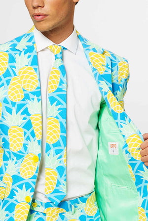 Man wearing blue summer suit with pineapple print. Chest close up.