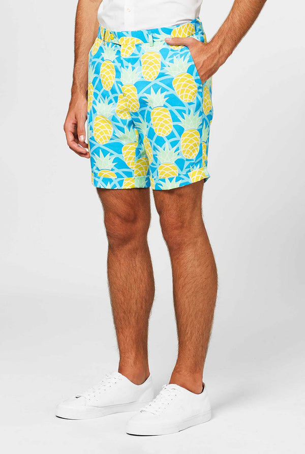 Man wearing blue summer suit with pineapple print. Shorts close-up.