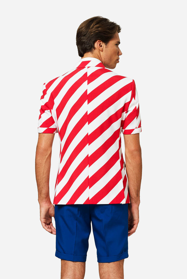 Person wearing a red and white striped blazer with blue shorts on a white background, view from the back.