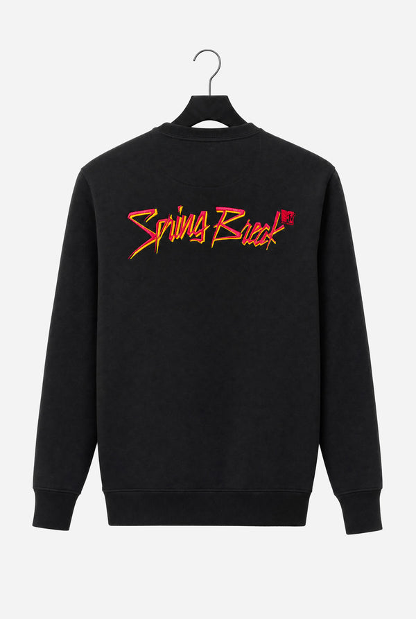 A black crewneck sweatshirt hanging on a black hanger against a light gray background, featuring a stylized 'Spring Break and MTV logo embroidery in Pink and yellow across the upper back.