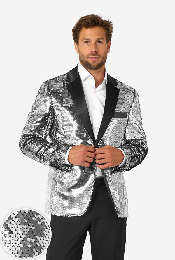 Man wearing a silver sequin jacket with black lapels on a white background