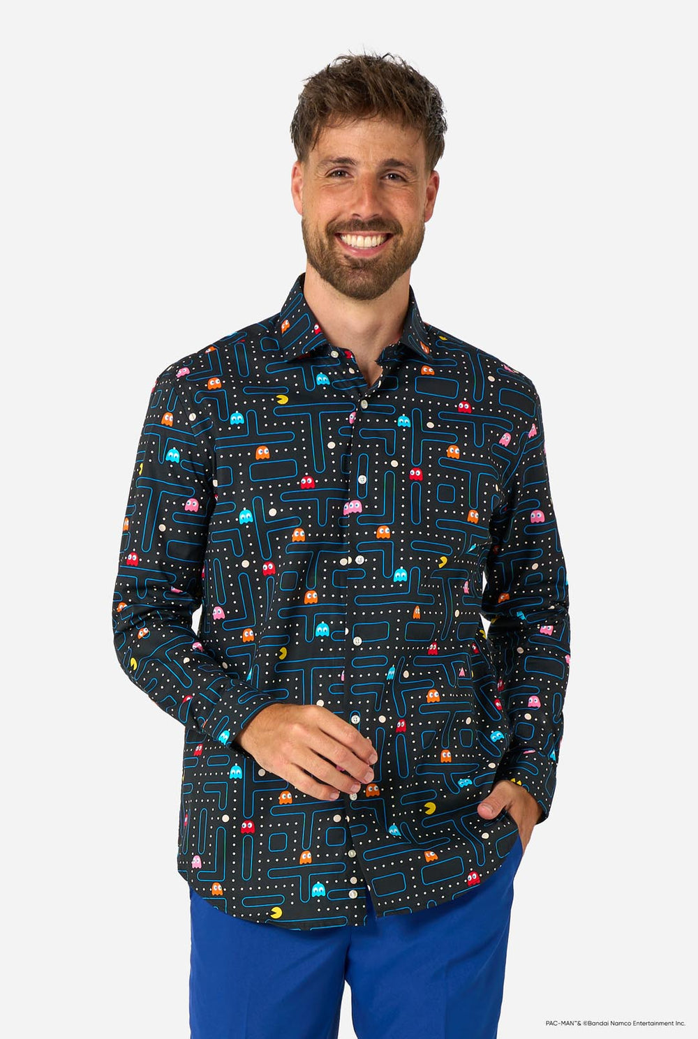 Image of a man wearing a black shirt with Pac-Man print and a blue pants. 