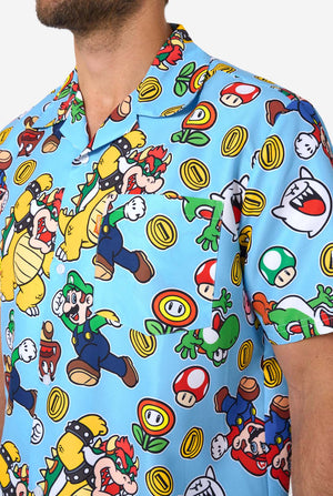 Man wearing a colorful Mario-themed shirt and shorts set on a light background. Chest close up.