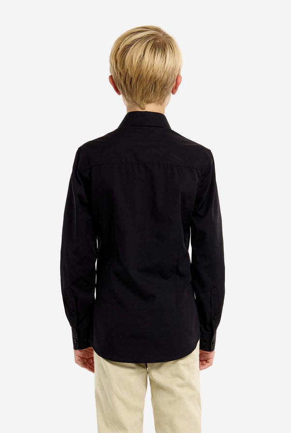 Person wearing a black shirt and beige pants on a white background, view from the back.