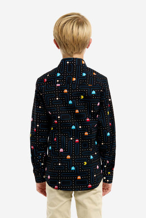 Young boy wearing a black shirt with colorful Pac-Man pattern on a white background, view from the back