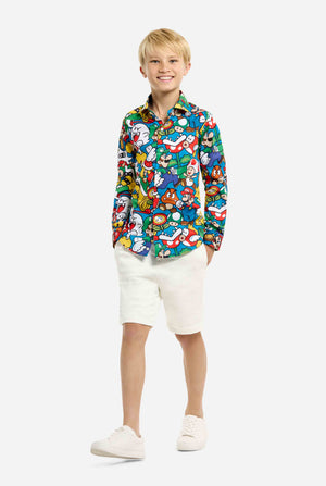 Image of teen wearing a Super Mario all over print shirt. Main color is blue, but there is also yellow, red and white. Kid also wearing shorts.