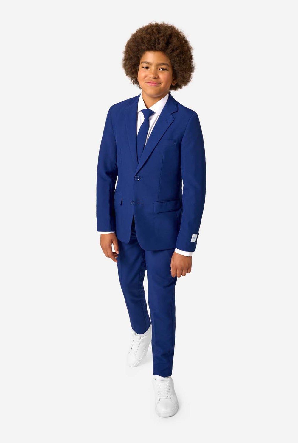 Kid wearing a navy blue suit with a white shirt and tie on a light gray background.