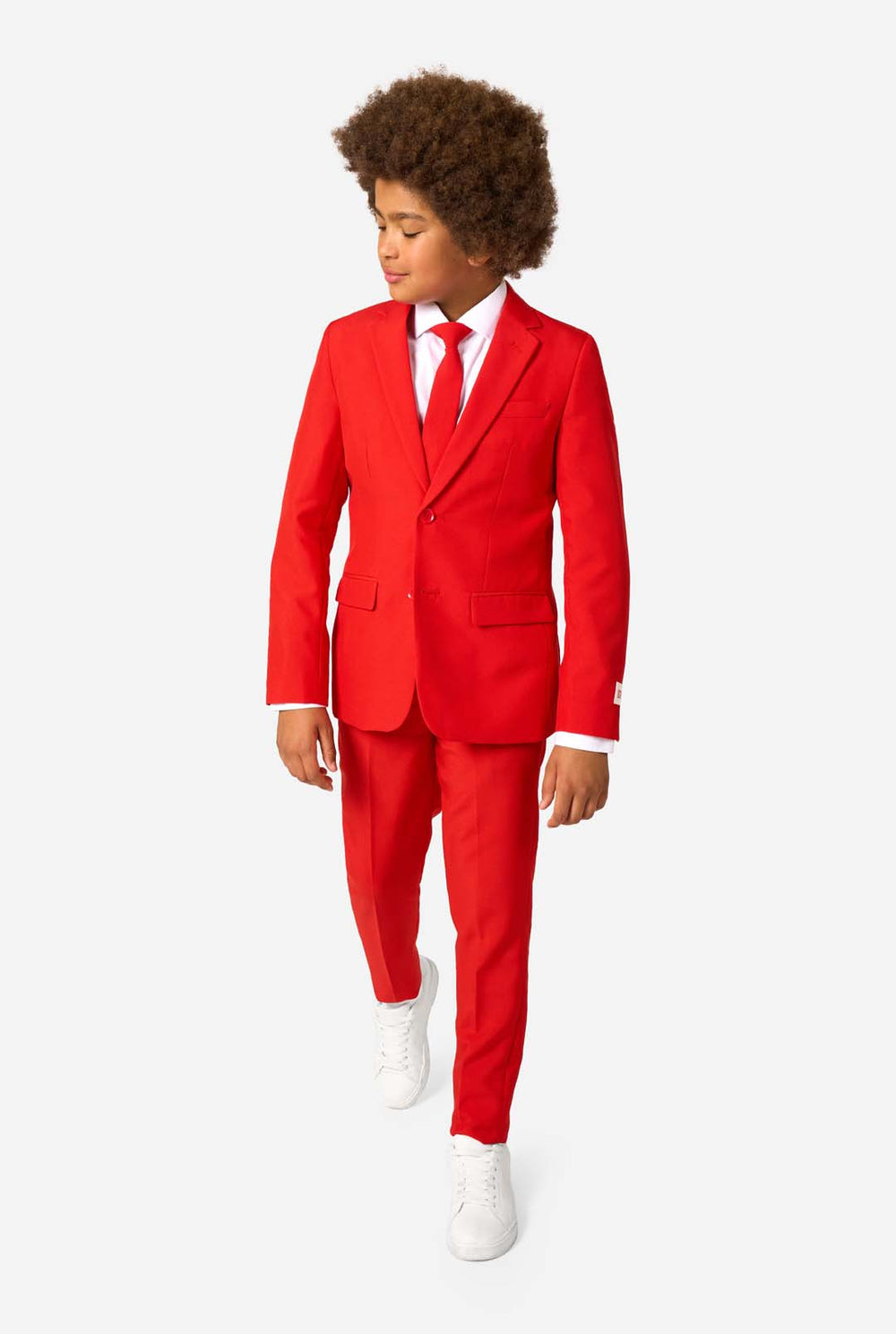 Child wearing a red suit with a white shirt and red tie on a white background