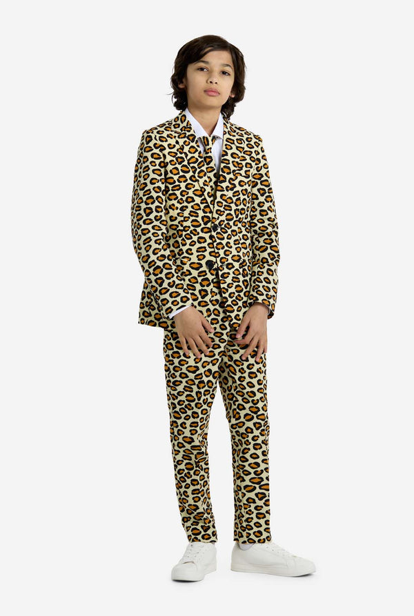 Person wearing a leopard print suit on a white background, full body image.