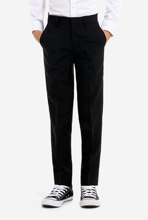 Person wearing black pants and white sneakers on a white background