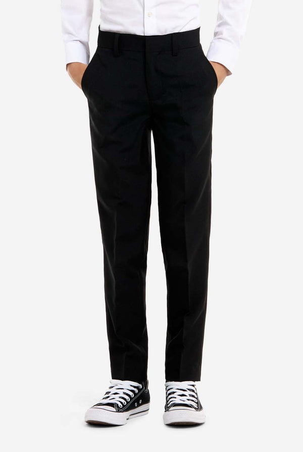 Person wearing black pants and white sneakers on a white background