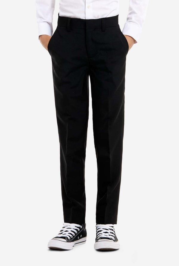 Person wearing black pants with a white shirt and black and white sneakers on a white background