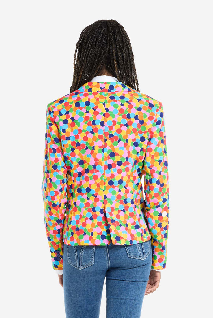 Woman wearing womens blazer with confetti print,, view from the back