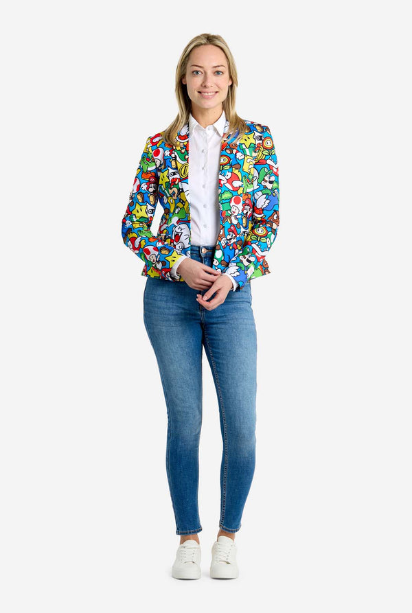 Woman wearing all-over print Super Mario blazer with iconic Super Mario characters. The base is light blue, but there is also yellow, red and white. Full body image.