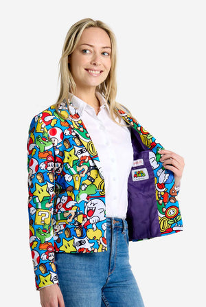 Woman wearing all-over print Super Mario blazer with iconic Super Mario characters. The base is light blue, but there is also yellow, red and white. Side view.