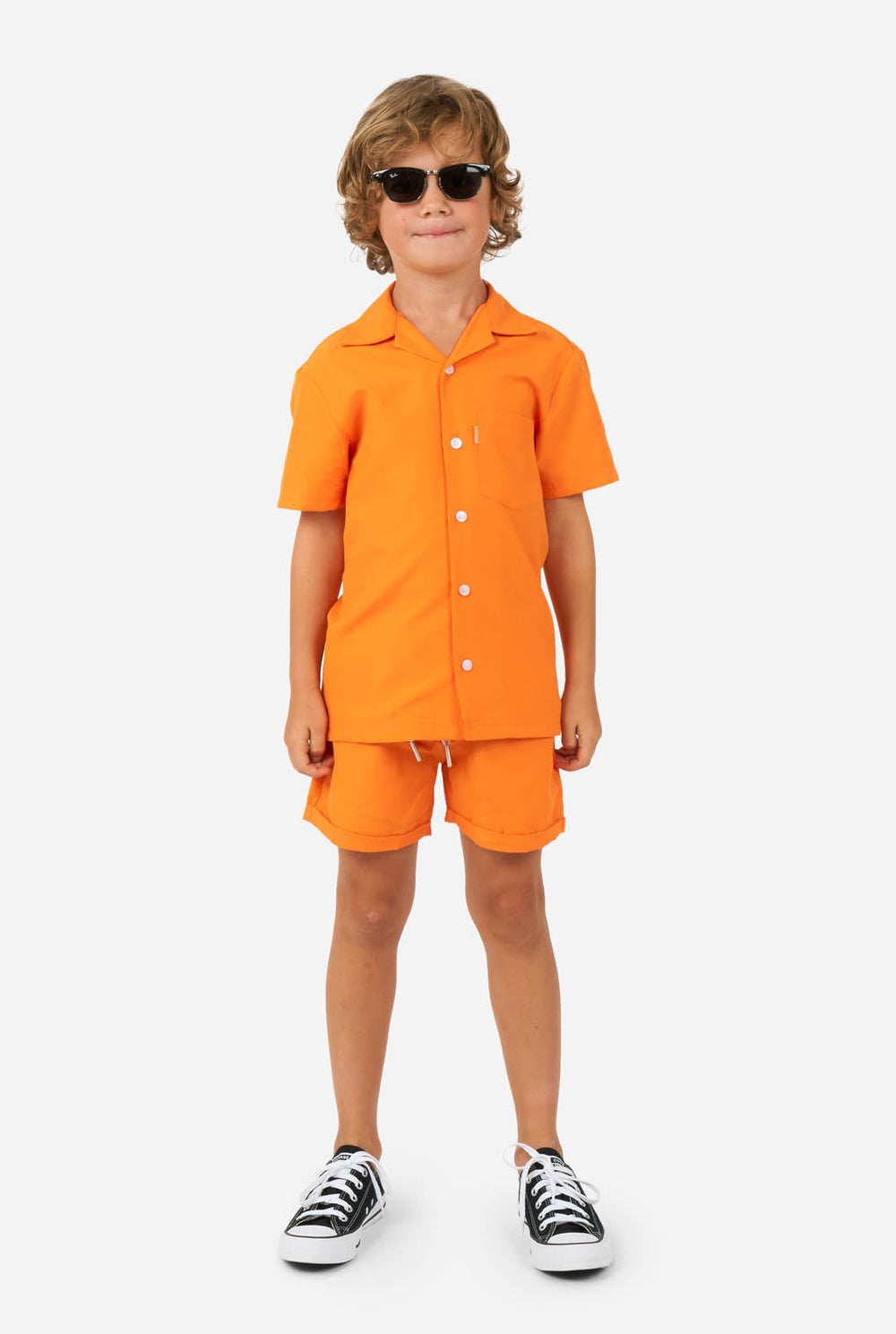 Boy wearing orange summer set, consisting of shorts and shirt 