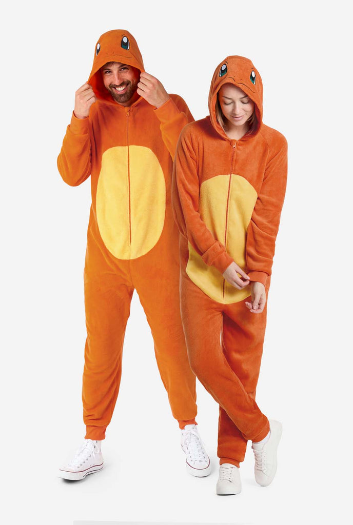 Man and woman are wearing an orange Pokemon Charmander Unisex onesie. Perfect for Pokemon fans. Full body image.