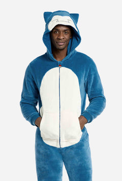 Person wearing a blue and white Snorlax onesie with cat ears on a light gray background