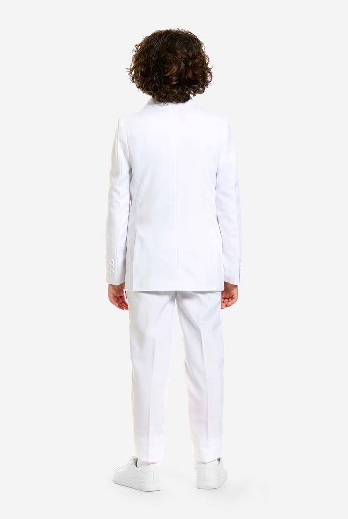 In this image, a kid is wearing a white suit for boys and white shirt. The consists of jacket, pants and clip-on tie. View from the back.