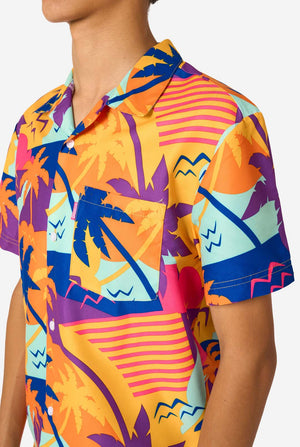 Person wearing a colorful Hawaiian shirt and shorts summer set on a white background. Chest close up.