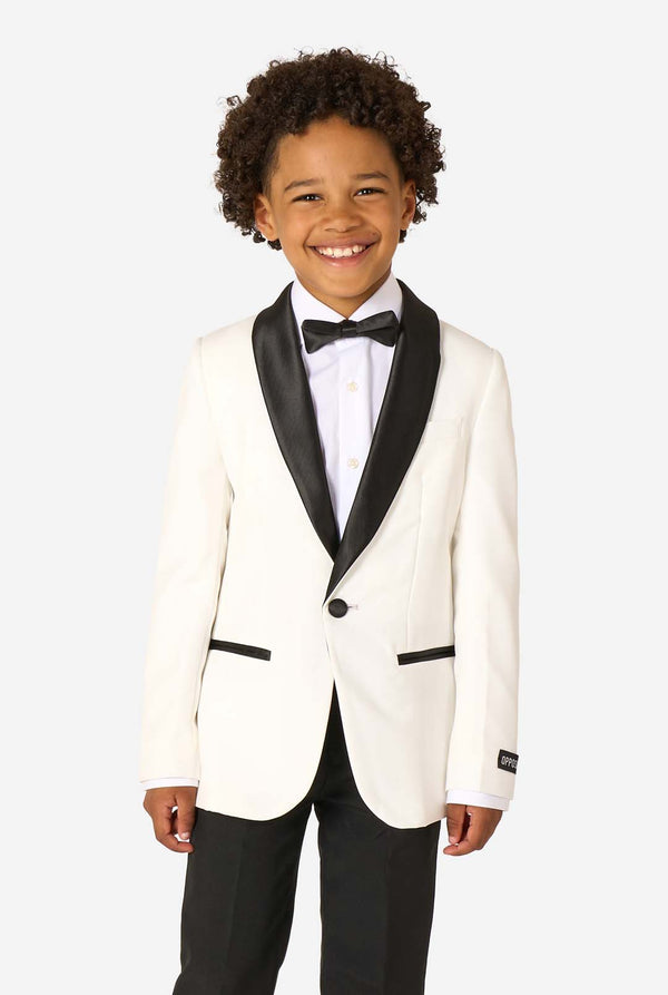 Child wearing a white tuxedo with black lapels and bow tie on a white background