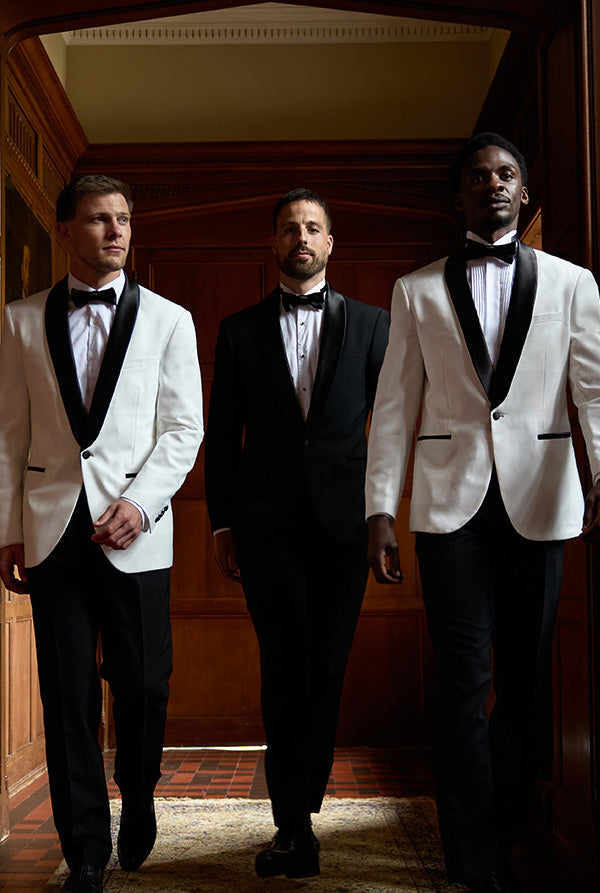 Image of three man wearing a tuxedo. Two wearing the Pearly White and the other one is wearing the Jet Set Black.