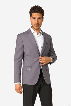 Man wearing a gray blazer over a white shirt on a white background