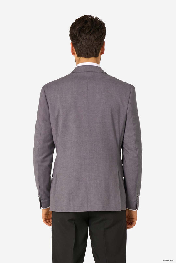 Back view of a man wearing a grey blazer and black trousers, showing the clean tailoring on the back.