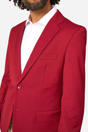 Red blazer worn by a person on a white background. Chest close up.