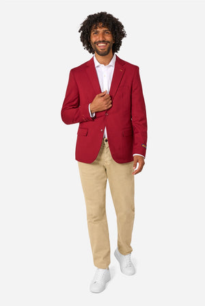 Man wearing a red blazer, white shirt, beige pants, and white shoes on a white background