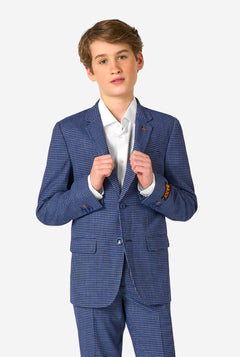 A teen boy wearing a navy and blue checkered suit with a white dress shirt. The suit has a modern fit with two buttons and flap pockets. He stands against a plain white background.