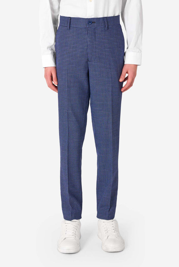 A teen boy wearing a navy and blue checkered suit with a white dress shirt. The suit has a modern fit with two buttons and flap pockets. He stands against a plain white background. Close up of the pants