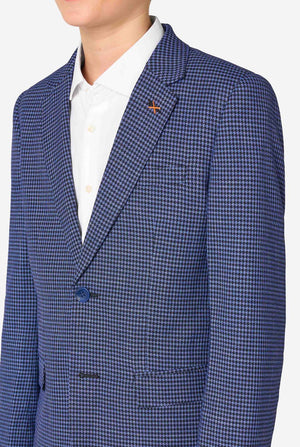A teen boy wearing a navy and blue checkered suit with a white dress shirt. The suit has a modern fit with two buttons and flap pockets. He stands against a plain white background. Close up of the chest