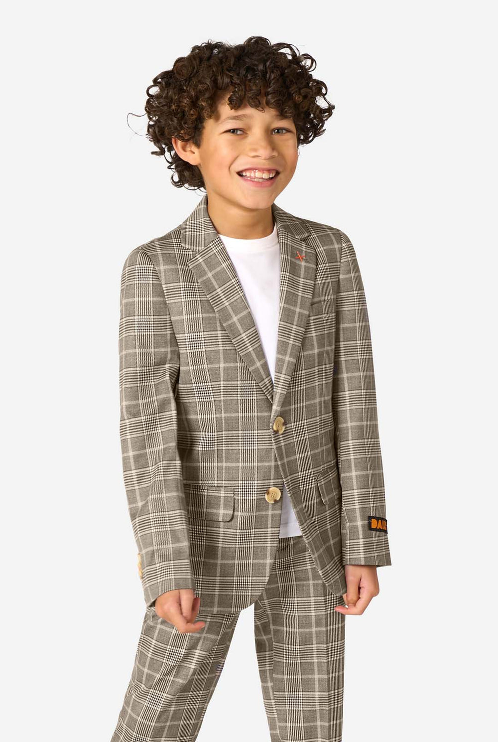 A boy wearing a tan checkered suit with a white dress shirt. The suit has a modern fit with two buttons and flap pockets. He stands against a plain white background. 