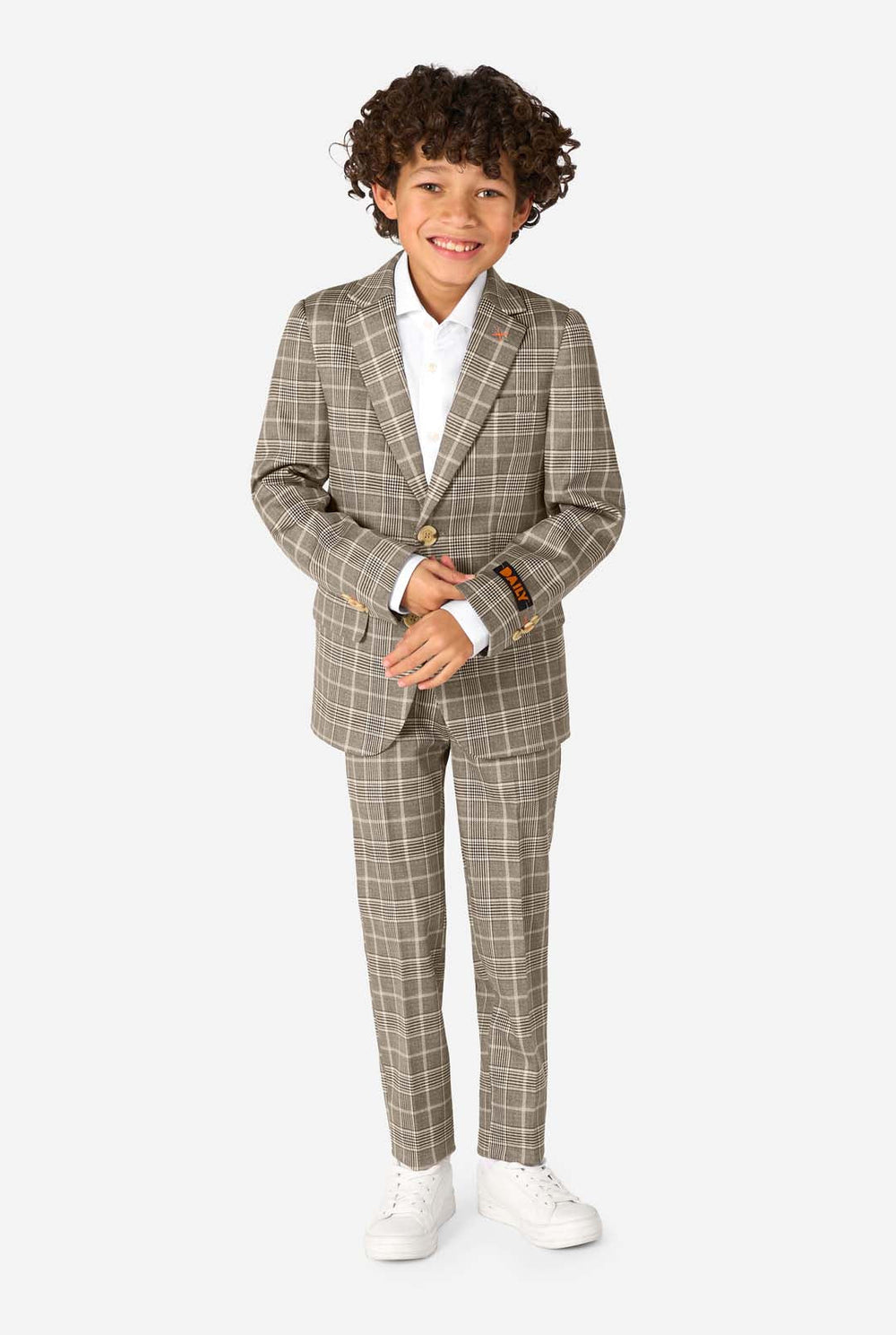 A boy wearing a tan checkered suit with a white dress shirt. The suit has a modern fit with two buttons and flap pockets. He stands against a plain white background. 