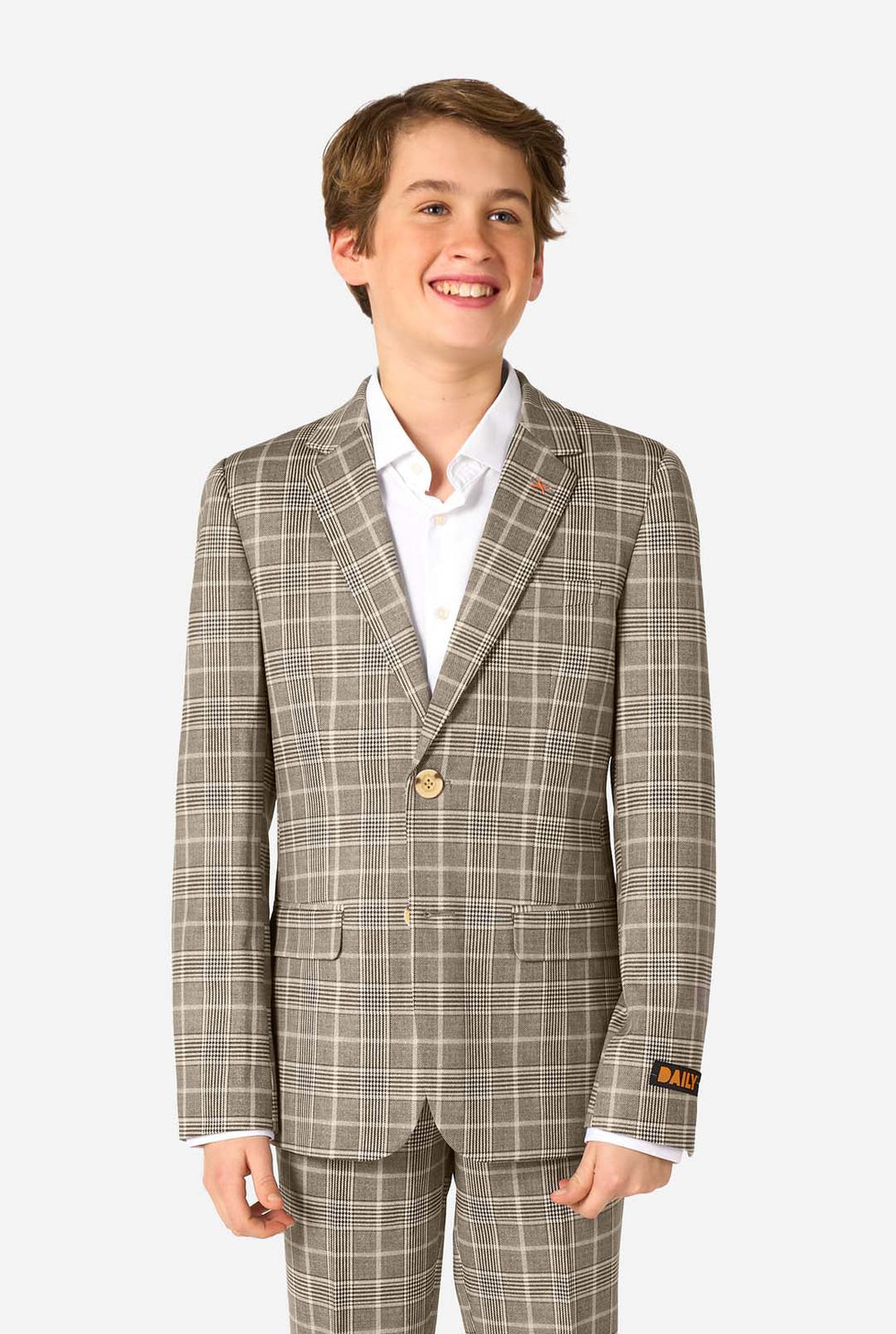 A teen boy wearing a tan checkered suit with a white dress shirt. The suit has a modern fit with two buttons and flap pockets. He stands against a plain white background. 