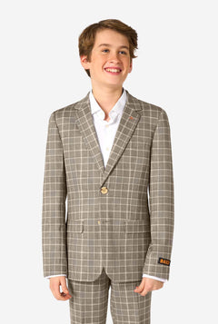 A teen boy wearing a tan checkered suit with a white dress shirt. The suit has a modern fit with two buttons and flap pockets. He stands against a plain white background. 