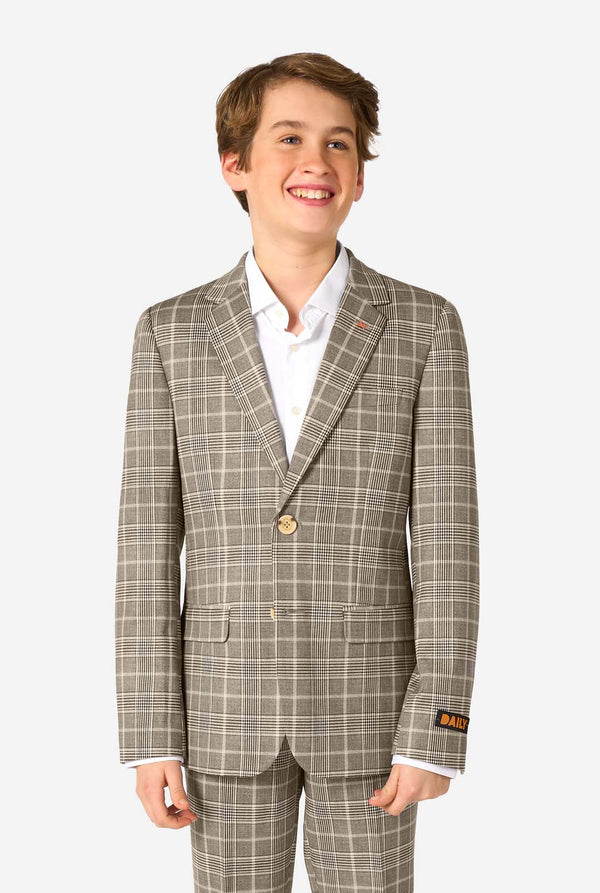 A teen boy wearing a tan checkered suit with a white dress shirt. The suit has a modern fit with two buttons and flap pockets. He stands against a plain white background. 
