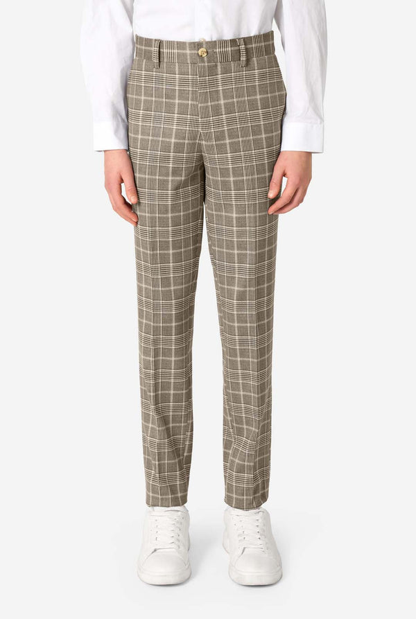 A teen boy wearing a tan checkered suit with a white dress shirt. The suit has a modern fit with two buttons and flap pockets. He stands against a plain white background. Close up of the pants