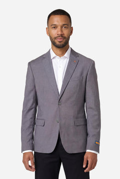 Man wearing a gray blazer over a white shirt on a white background