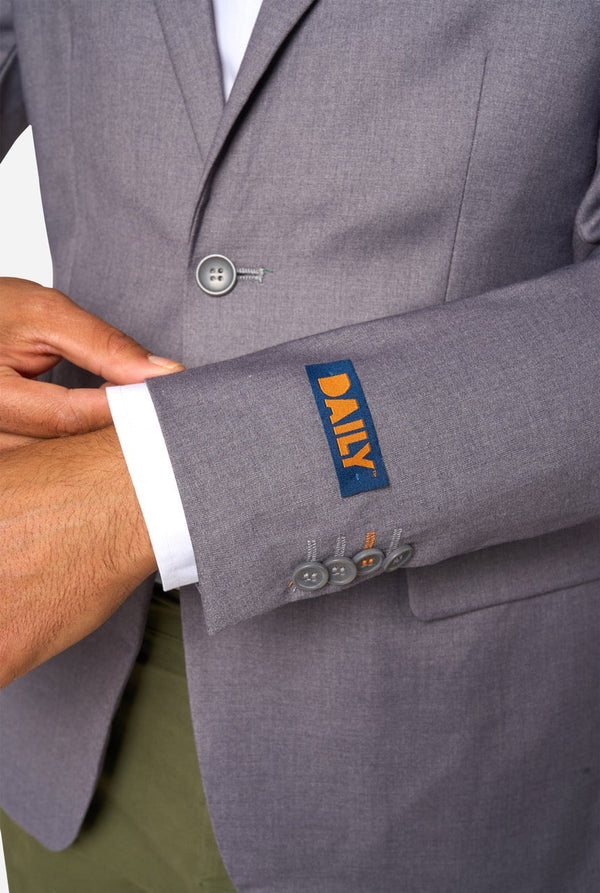 Gray suit jacket with a brand label on the sleeve