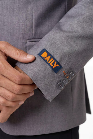 Gray suit jacket with a 'DAILY' logo on the sleeve