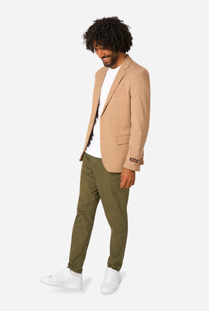 Man wearing a beige blazer, white shirt, and green pants on a white background