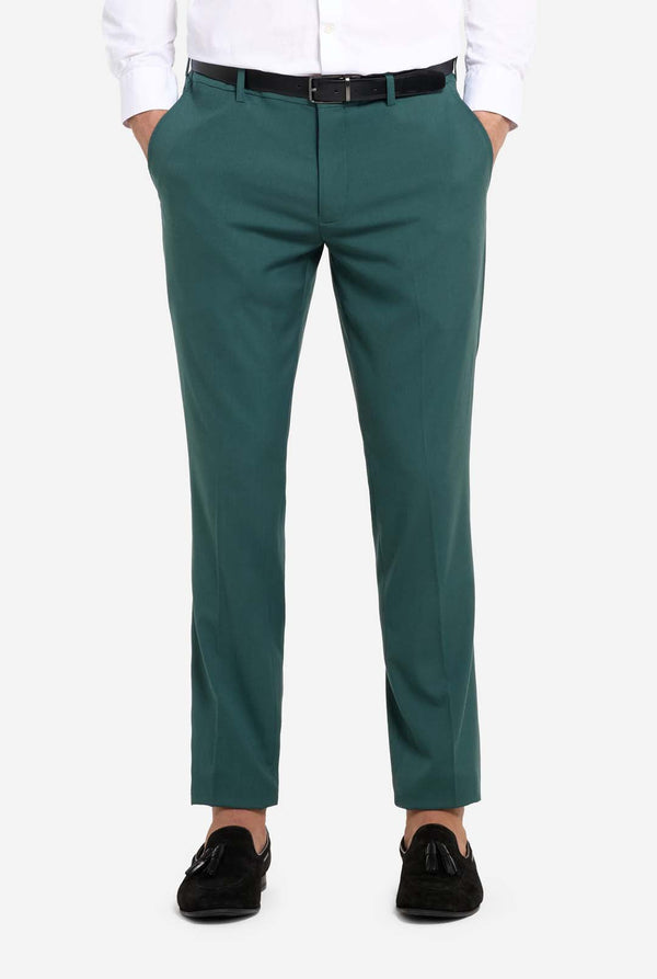 Image with light grey background and man wearing dark green men’s suit and white shirt. Suits consists of blazer and pants. Pants close up.