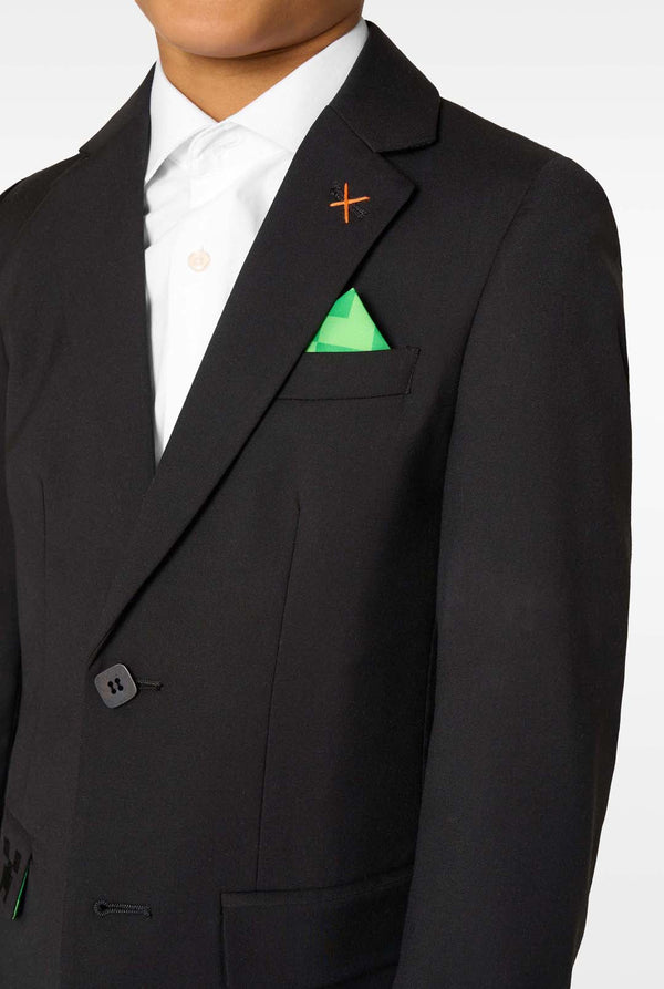 Close-up of the blazer chest showing an orange cross-stitch detail and a green patterned pocket square.